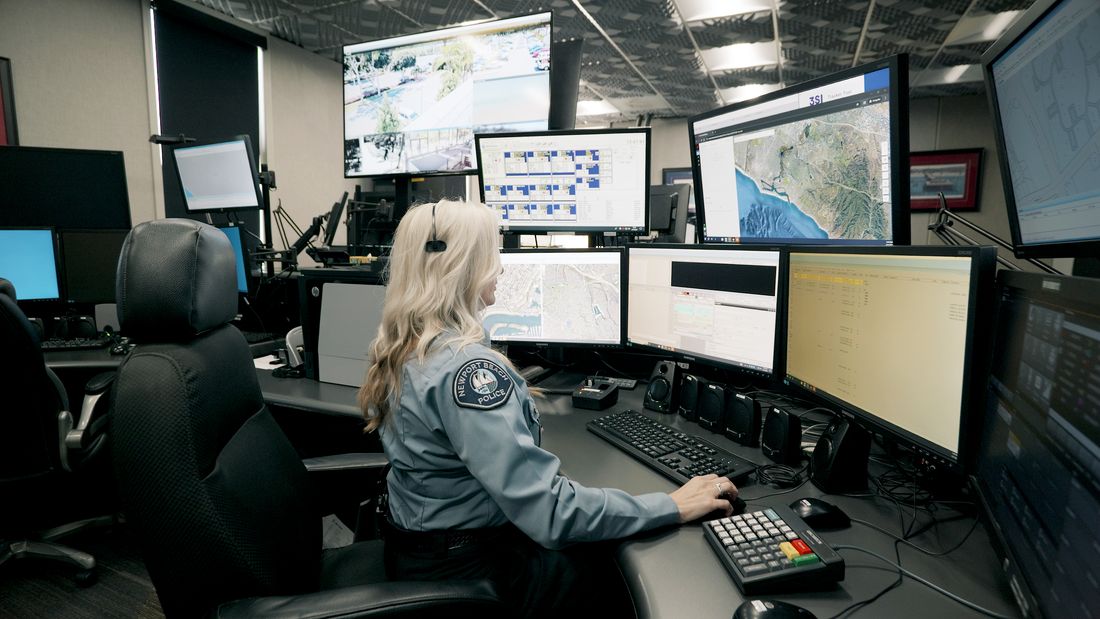 NBPD dispatcher at her console in the communications center